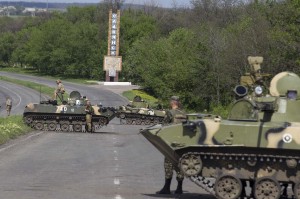 Ukrainian soldiers, supported by armoured personnel carriers, man a checkpoint near the town of Slaviansk in eastern Ukraine